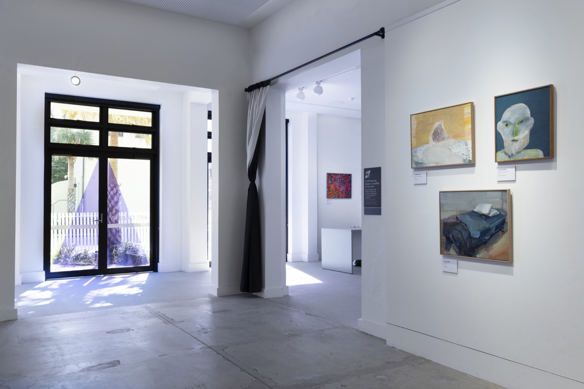 Waverley Art Prize gallery with wall-mounted artworks, captions and visitor information signage.