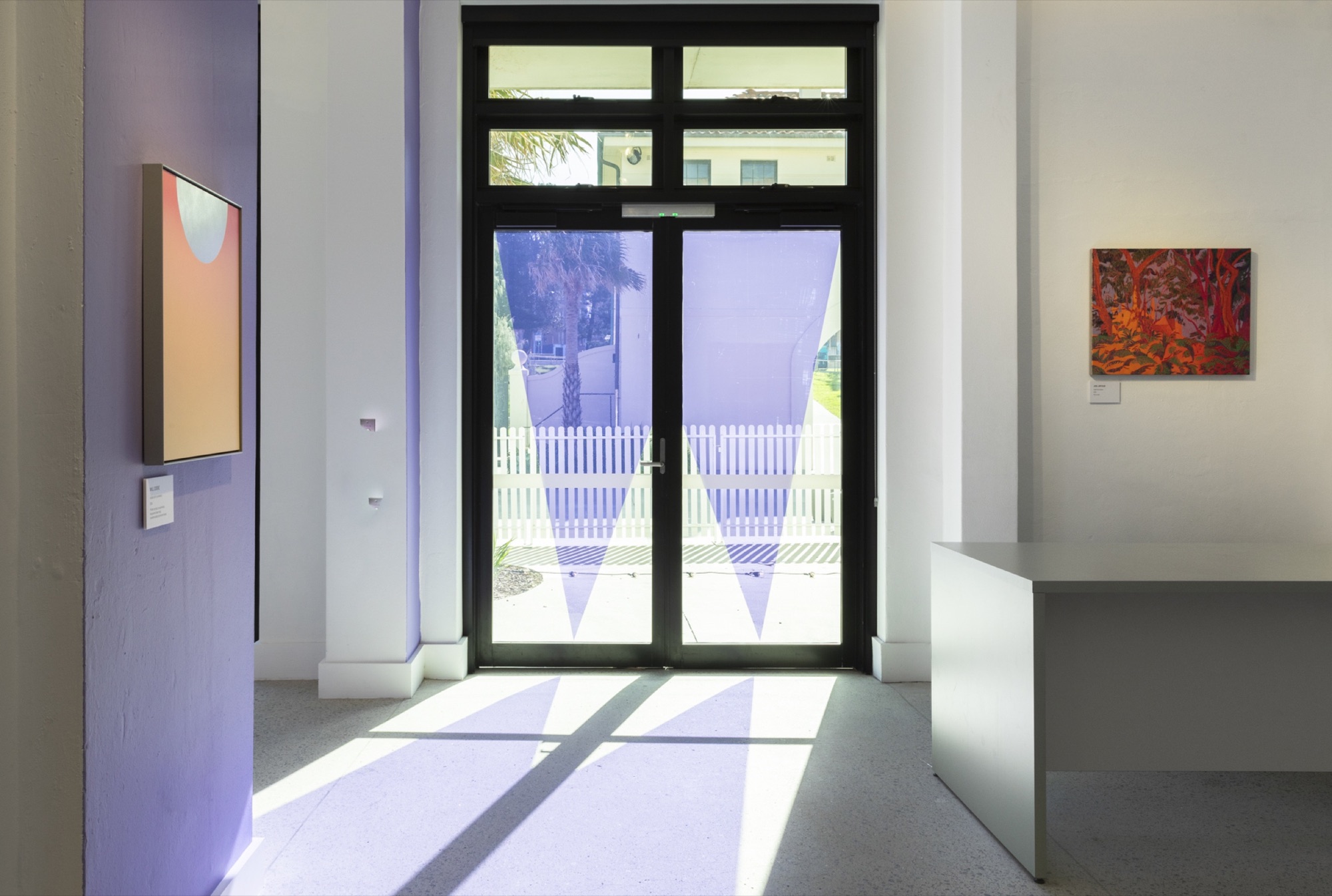 Purple window graphics and artwork labels installed across the Waverley Art Prize gallery.